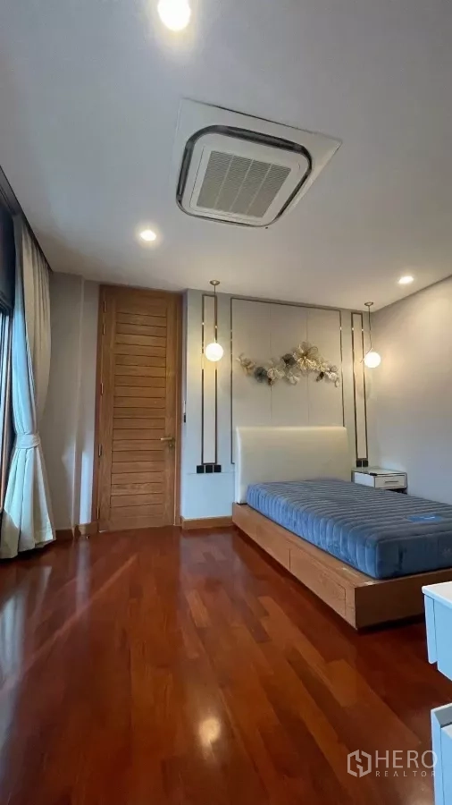 Detached House for rent in Prawet, Bangkok - Guest bedroom with bed, pendant lights and balcony curtains.