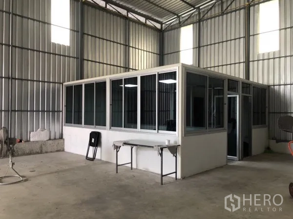 Warehouse for rent in Wang Thonglang, Bangkok - Glass-partitioned office room inside the warehouse with desks and windows.