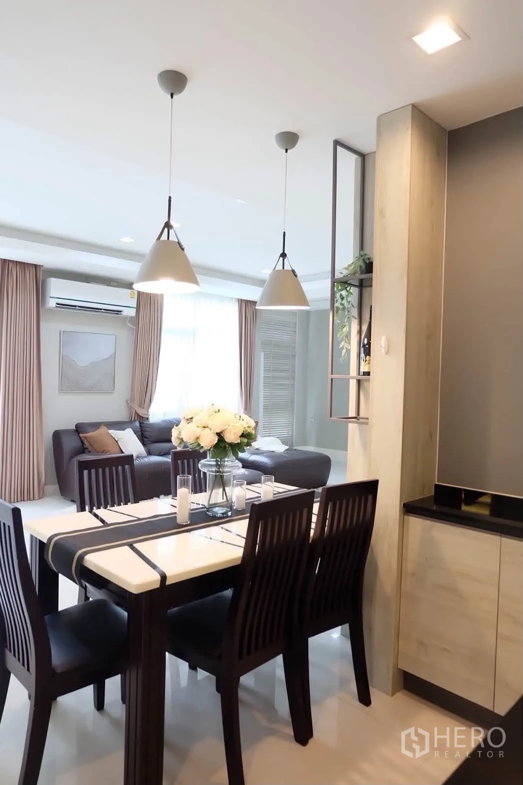 Detached House for rent in Bang Phli, Samut Prakan - Dining table for six beside pendant lights and view to living room.