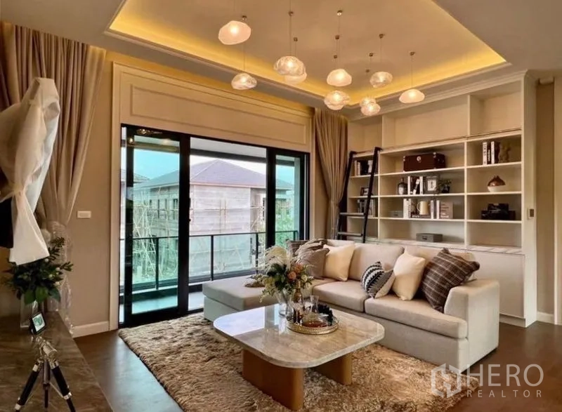 Detached House for sale in Bang Phli, Samut Prakan - Upstairs family lounge with pendant lights, built-in shelves and balcony access.