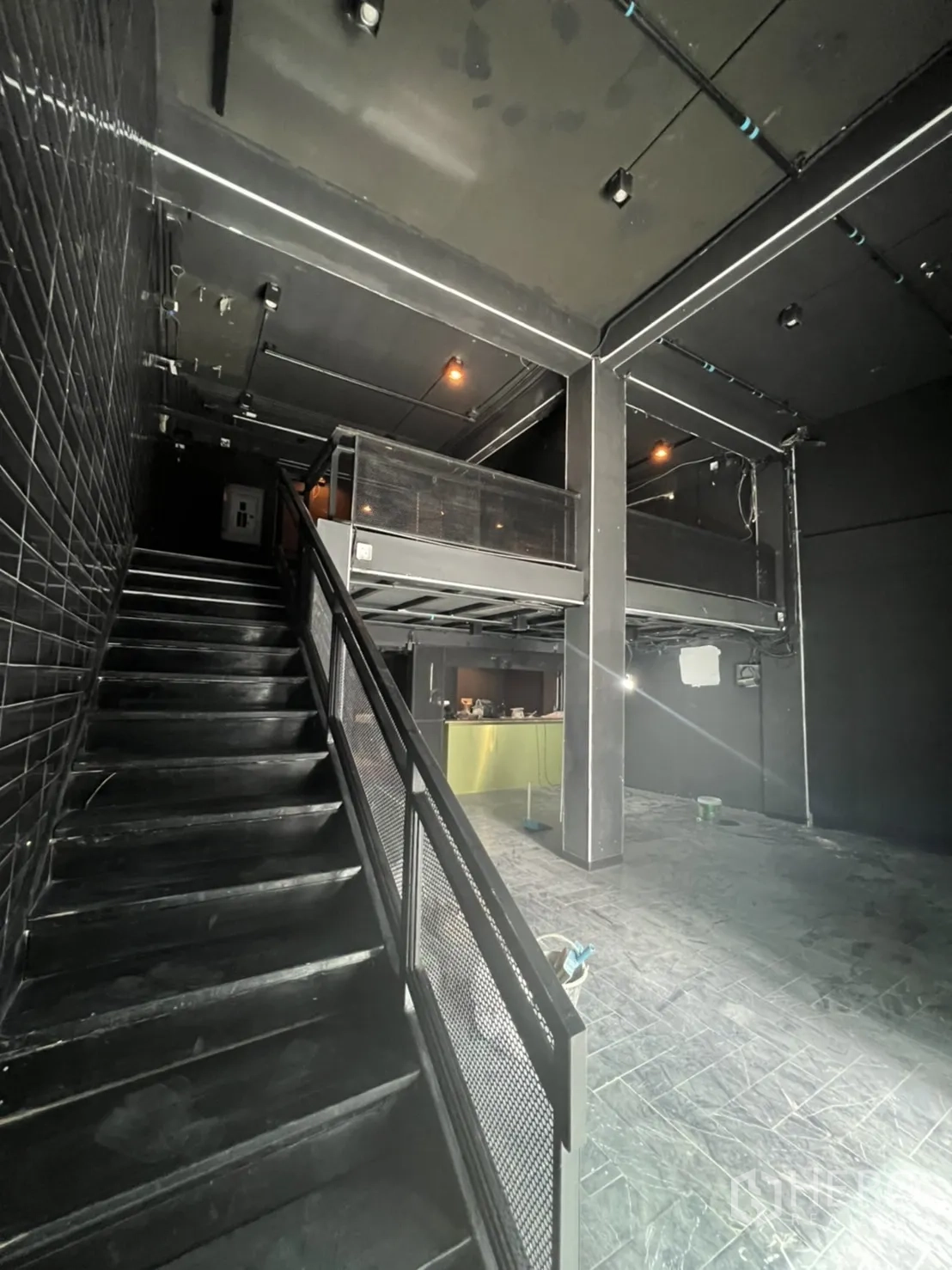 Home Office for rent or sale in Khlong Toei, Bangkok - Industrial staircase leading to a mezzanine above a double-height space.