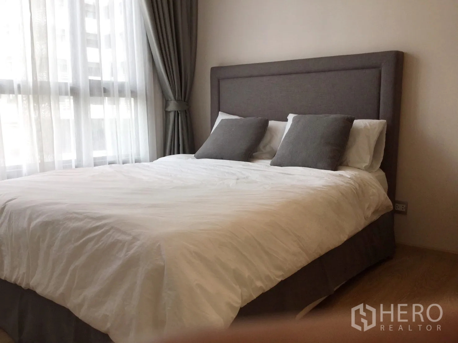 公寓 出租或出售在Watthana, Bangkok - 温馨卧室，软包床头、大窗与素雅配色。