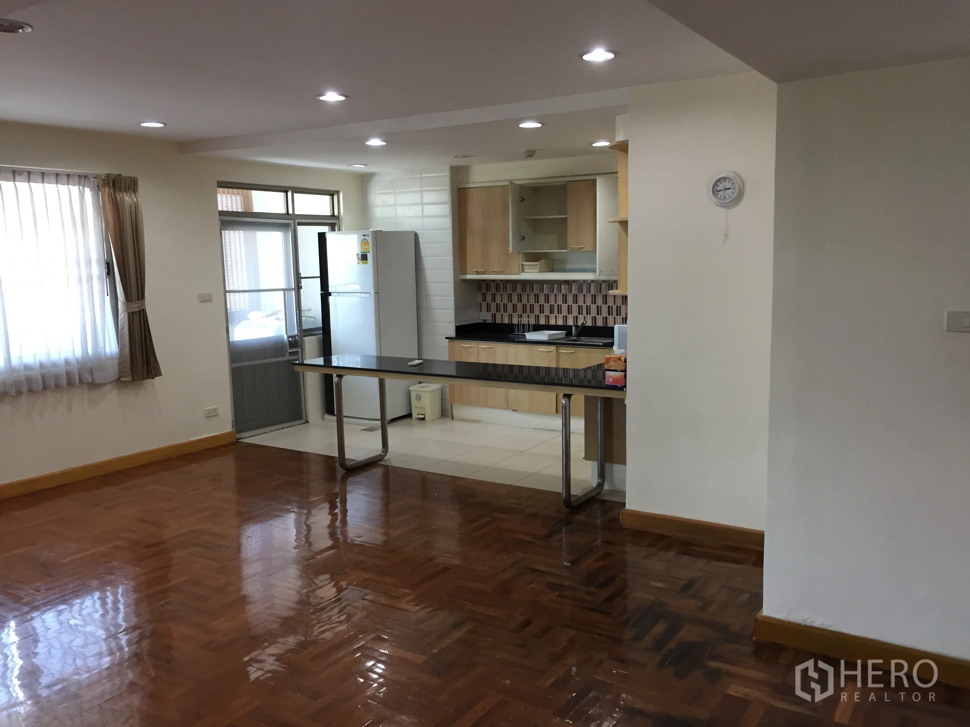 คอนโด ให้เช่าในWatthana, Bangkok - ครัวสว่างพร้อมเคาน์เตอร์บาร์ ตู้เย็นขนาดใหญ่ และประตูออกสู่ระเบียงซักล้าง