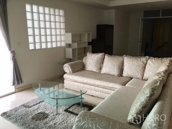 คอนโด ให้เช่าหรือขายในKhlong Toei, Bangkok - โซฟาเข้ามุม โต๊ะกลางกระจก พรม และช่องแสงบล็อกแก้วในห้องนั่งเล่น