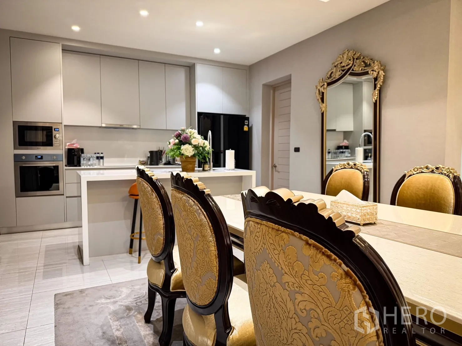 Detached House for rent or sale in Lak Si, Bangkok - Modern kitchen with island, built-in ovens, and adjacent dining table.