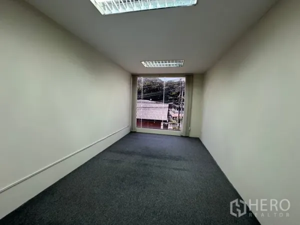 Office Space for rent - Private office with floor-to-ceiling window facing the neighborhood.