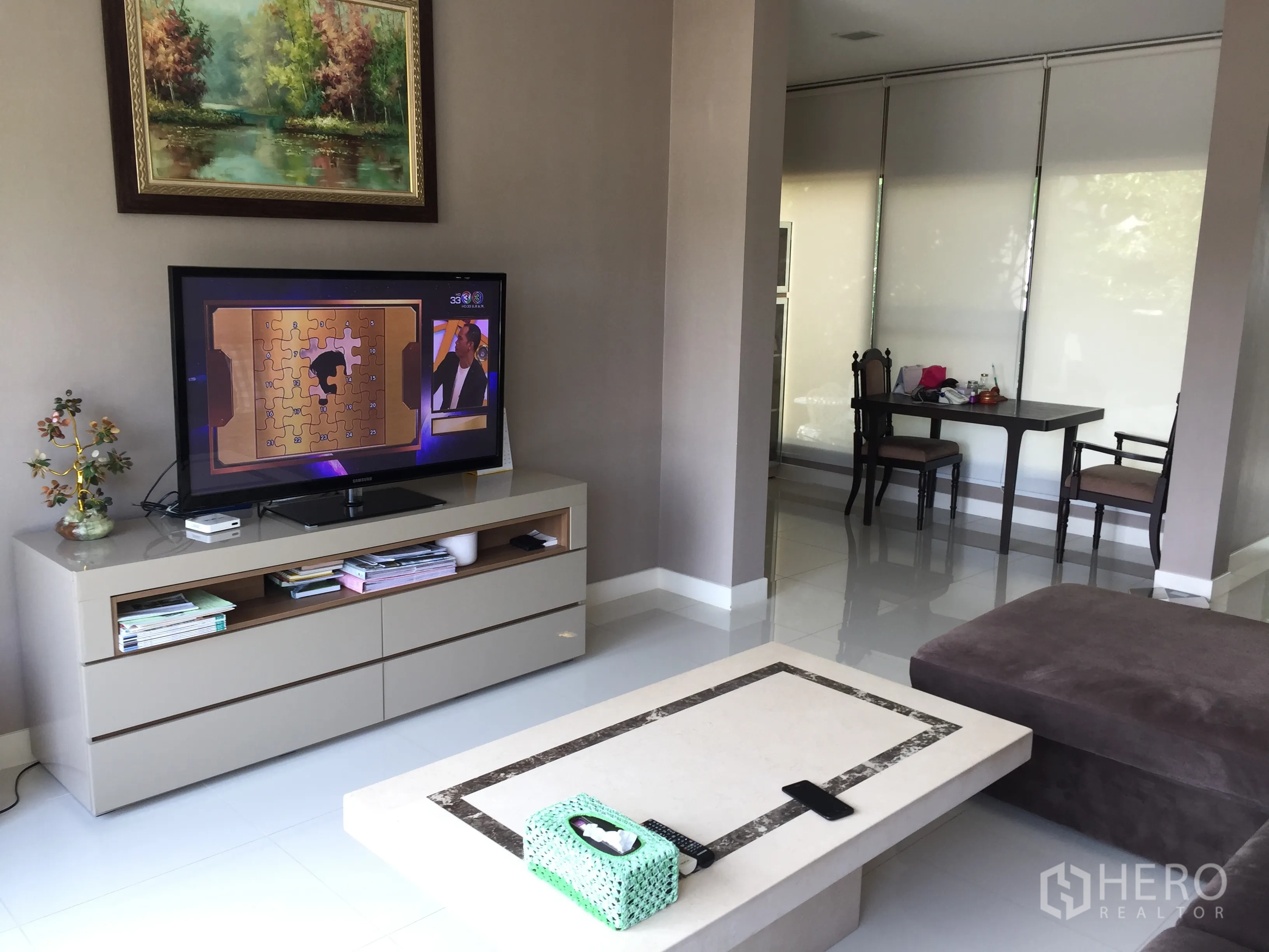Detached House for rent or sale in Prawet, Bangkok - Cozy TV corner with modern media console and an adjacent study nook with window blinds.
