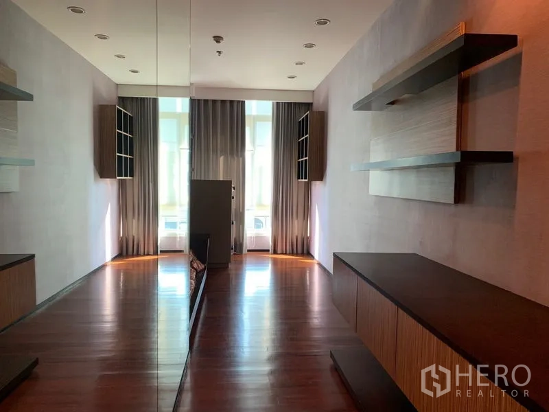 Condominium for rent - Flexible room with full-height mirror, floating shelves, and floor-to-ceiling curtains.