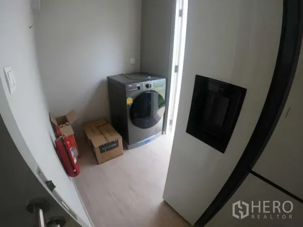 Townhouse for rent - Compact laundry room with washing machine and door opening to the side yard.