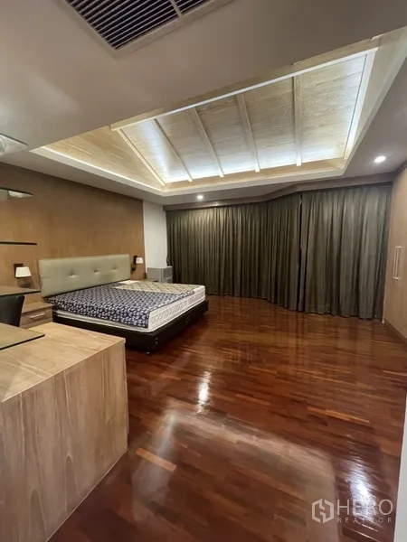 Home Office for rent or sale in Phra Khanong, Bangkok - Large master bedroom with tray ceiling, wooden floors and a king-size bed.