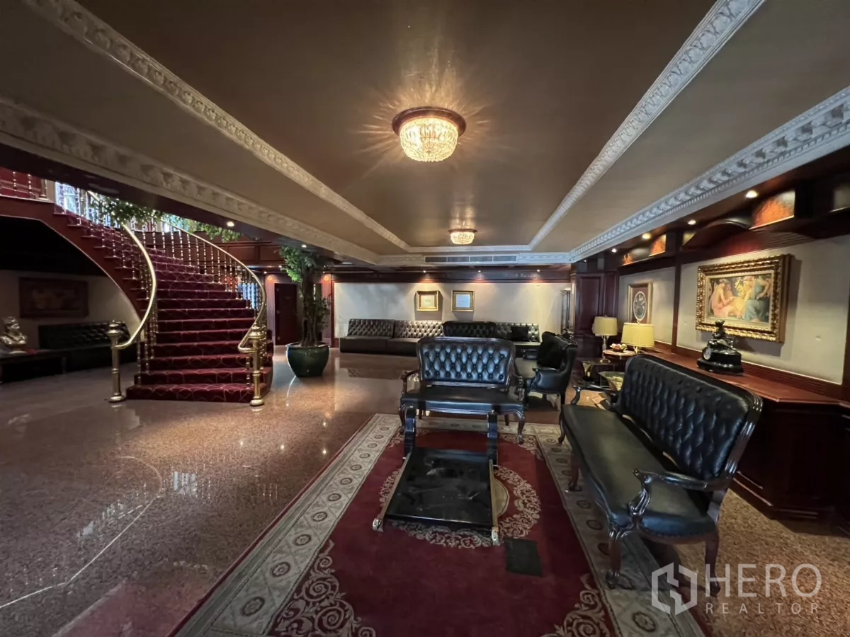 Retail Space for rent in Watthana, Bangkok - Elegant lobby with leather seating, wood paneling and a central staircase.