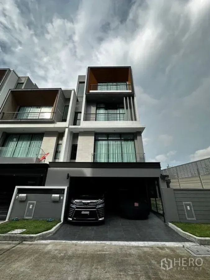 Townhouse for sale - Modern four‑storey townhouse facade with balconies and driveway parking.