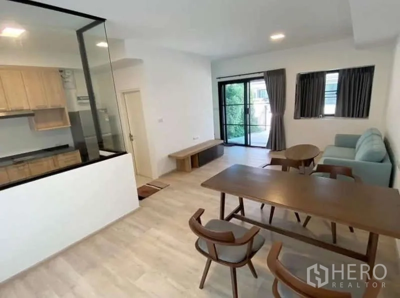 Townhouse for rent in Bang Phli, Samut Prakan - Dining area overlooking front patio through sliding doors and side windows.