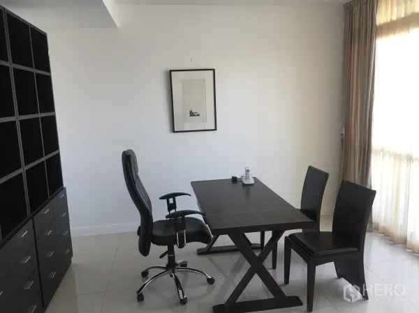 Condominium for rent in Pathum Wan, Bangkok - Bright home office area with dark wood desk, chairs, shelving and a large window with curtains.