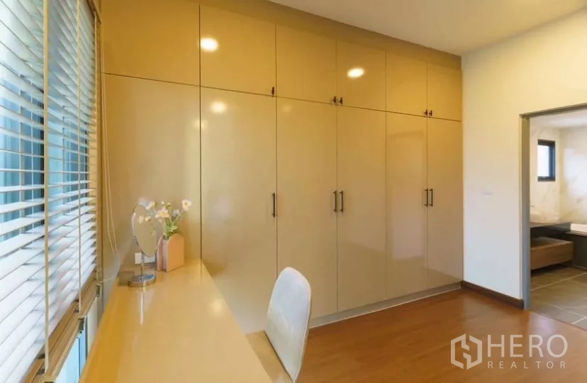 Detached House for rent or sale in Bang Phli, Samut Prakan - Walk-in closet lined with full-height cabinets and doorway to the bathroom.