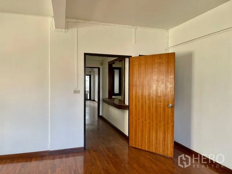 Home Office for rent - Bedroom doorway opening to a corridor with a built-in wooden counter.