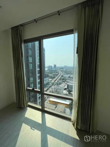 Condominium for sale - Corner window with sunlight and expansive city and highway views.