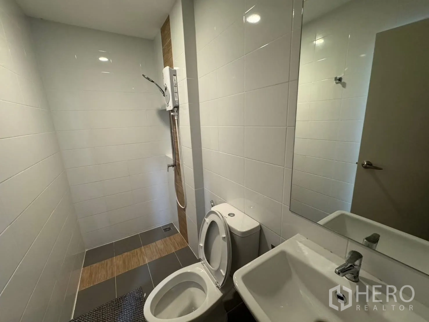 Townhouse for rent in Bang Phli, Samut Prakan - Clean bathroom with shower area, water heater, toilet, and vanity.