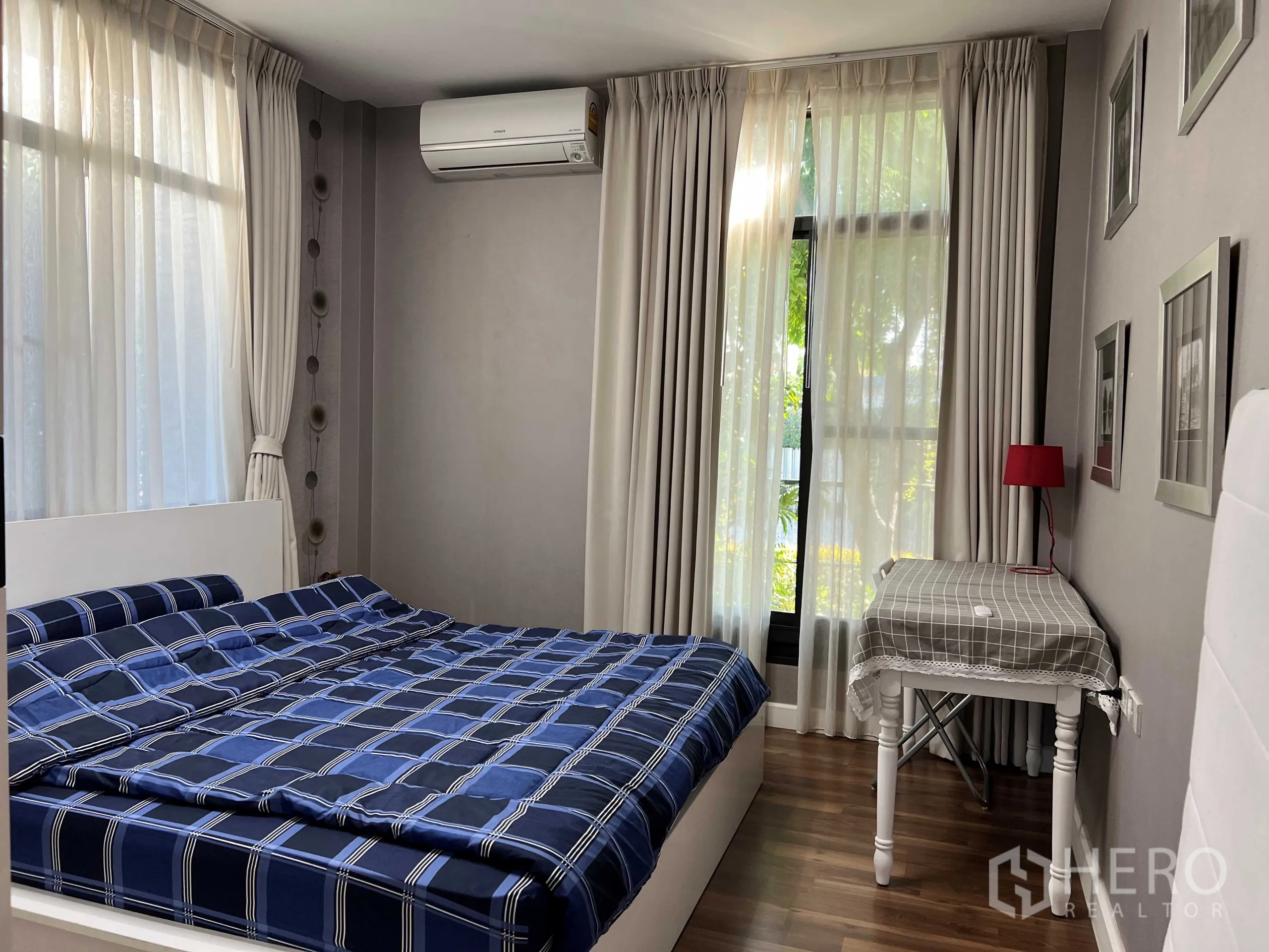 Detached House for rent in Prawet, Bangkok - Guest bedroom with big windows, sheer curtains and bedside table.