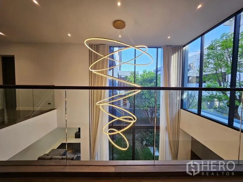 Detached House for rent in Bang Kapi, Bangkok - Double‑height atrium with spiral LED chandelier and full‑height glass