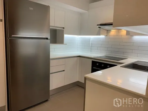 คอนโด ขายในWatthana, Bangkok - ครัวยูเช็ปสีขาวพร้อมตู้เย็นสแตนเลส เตาอบ และผนังอิฐขาว