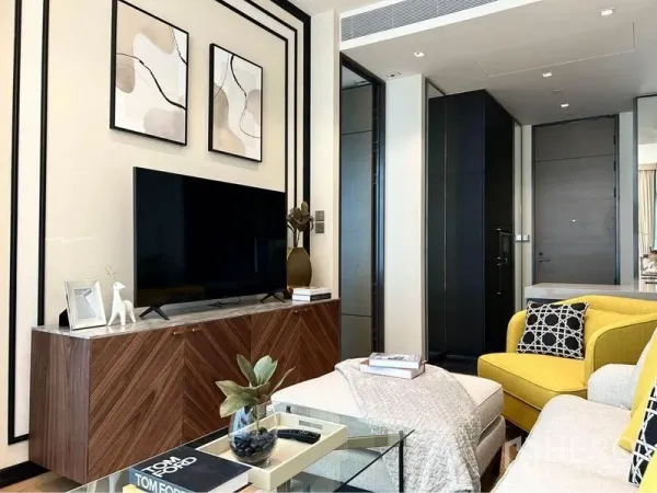 Condominium for rent in Pathum Wan, Bangkok - Contemporary living room with wood TV console, yellow accent chair and neutral sofa.