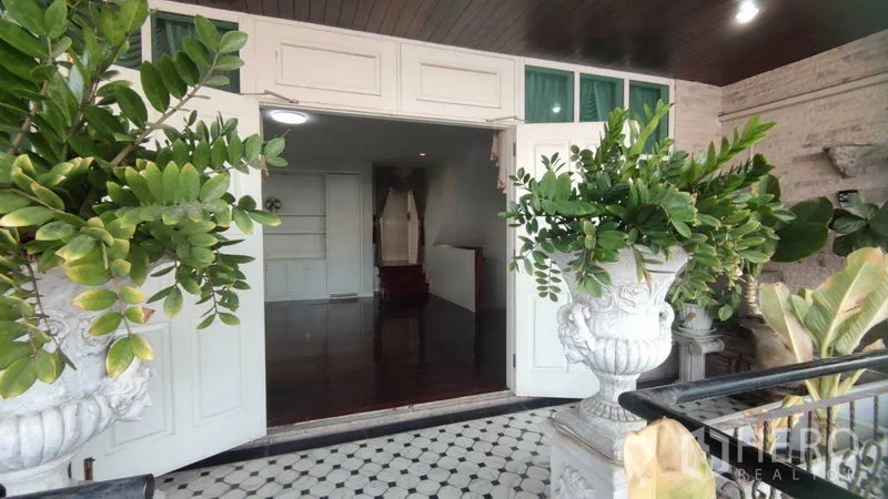 Home Office for rent in Watthana, Bangkok - Upper terrace with large planters leading to double doors and checker-tile floor.