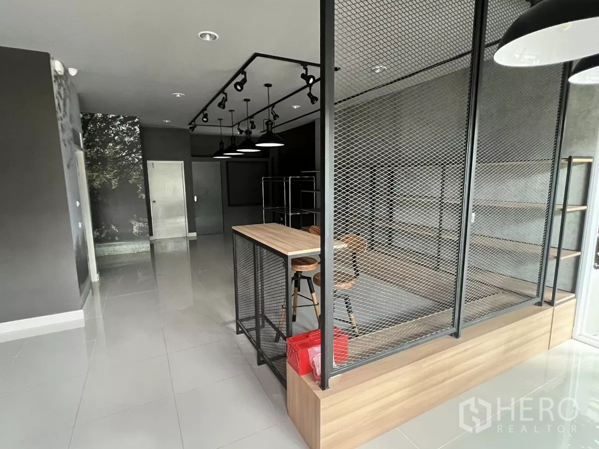 Detached House for rent or sale in Don Mueang, Bangkok - View of counter island with bar stools and black mesh divider.