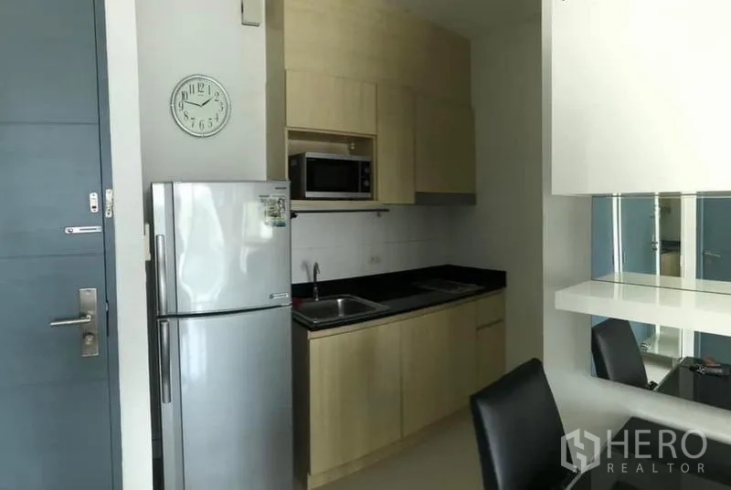 Condominium for rent or sale - Compact kitchenette with fridge, microwave, cabinets and breakfast bar.
