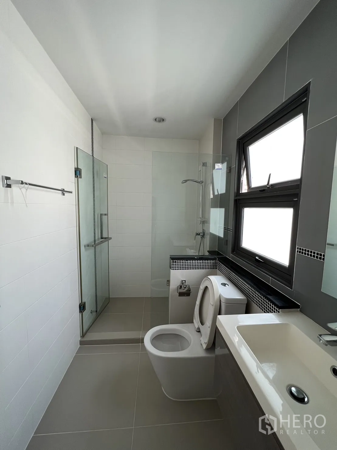 Detached House for sale in Suan Luang, Bangkok - Bright bathroom with walk-in shower next to window.