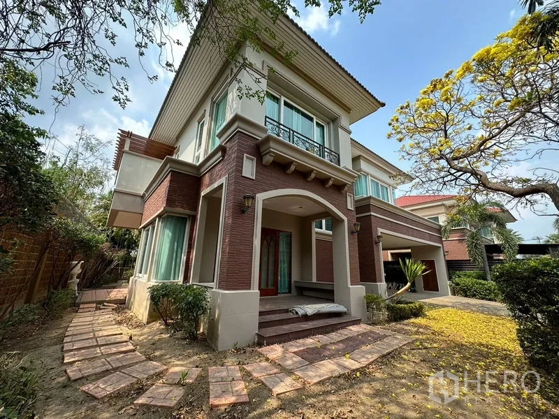 Detached House for rent or sale in Pak Kret, Nonthaburi - Two-storey detached house in Pak Kret with brick facade, front porch and garden path.