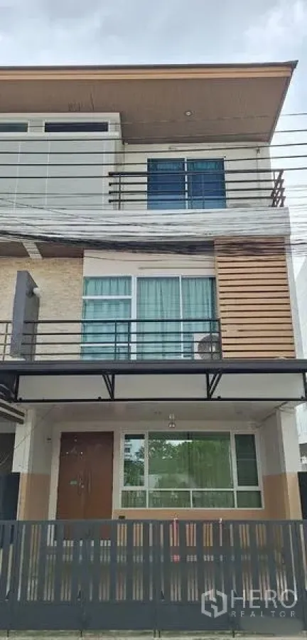 Home Office for rent in Bueng Kum, Bangkok - Close-up of the three-storey exterior showing balcony railings and windows.