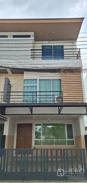 Home Office for rent in Bueng Kum, Bangkok - Close-up of the three-storey exterior showing balcony railings and windows.