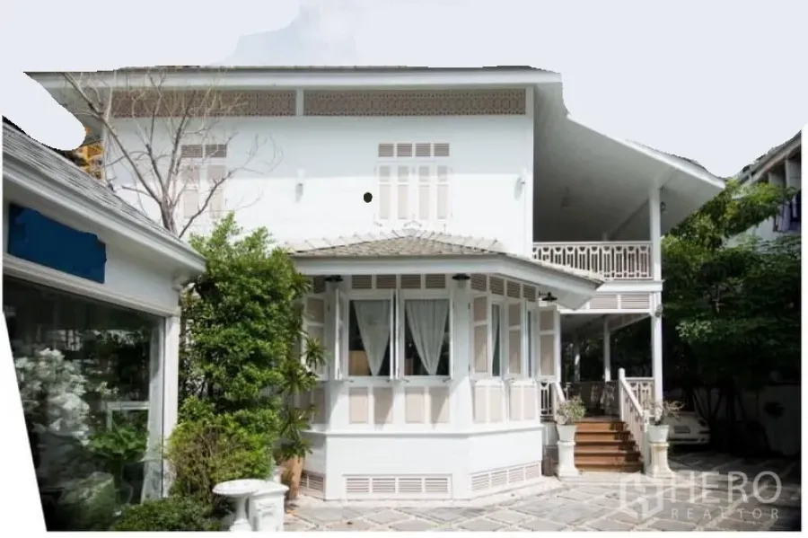 Detached House for rent in Bang Rak, Bangkok - Front facade of a white colonial-style house with bay window and side veranda.