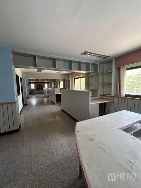 Warehouse for rent in Sam Phran, Nakhon Pathom - Office area inside the facility with built-in counters, open shelving and large windows.