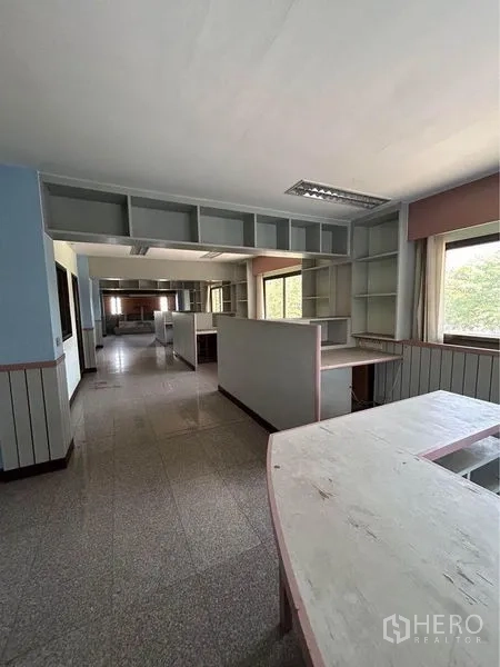 Warehouse for rent in Sam Phran, Nakhon Pathom - Office area inside the facility with built-in counters, open shelving and large windows.