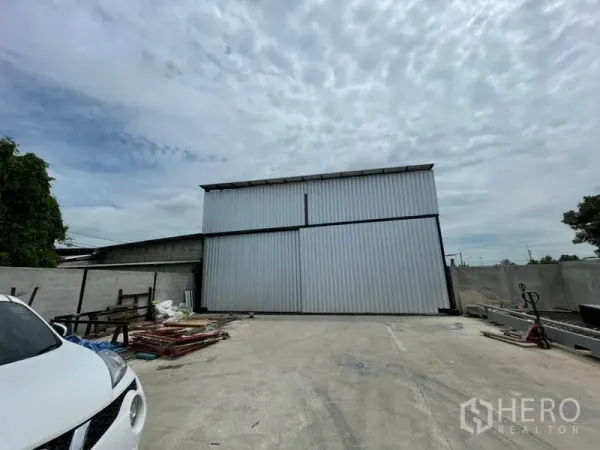 货栈 出租或出售在Khlong Luang, Pathum Thani - 远景展示仓库立面与宽敞车道，适合卡车调头，四周设围墙。