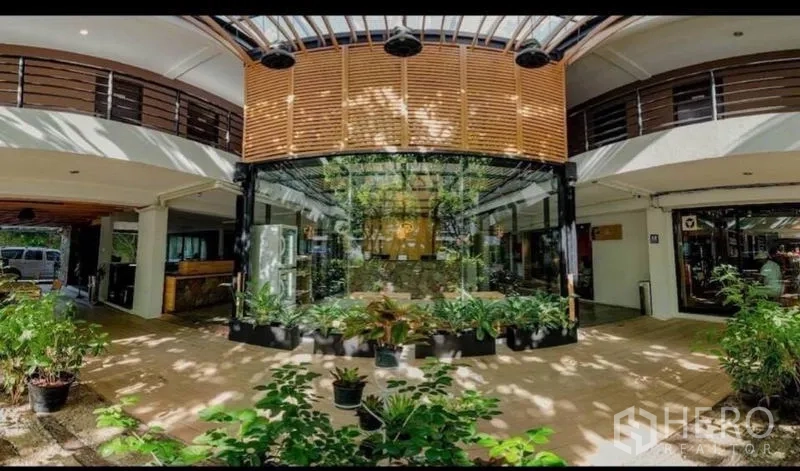 零售空间 出售在Phra Nakhon, Bangkok - 一层中庭大堂，玻璃立面与大量盆栽绿植。