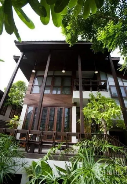 Detached House for sale in Suan Luang, Bangkok - Modern Thai‑style house exterior with tall wooden columns, deck and tropical plants.
