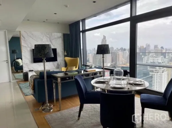 Condominium for sale in Ratchathewi, Bangkok - Stylish living and dining area with floor-to-ceiling windows and panoramic Bangkok skyline views.