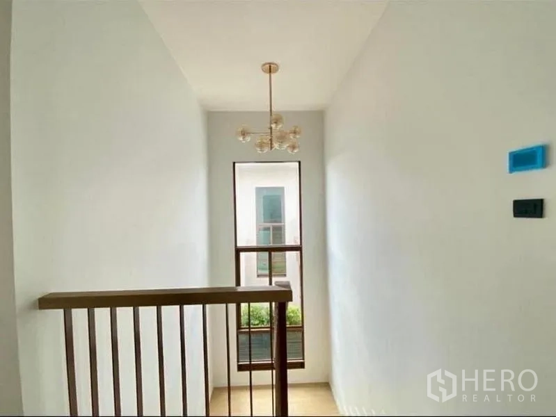 บ้าน ขายในBang Kapi, Bangkok - โถงบันไดพร้อมโคมไฟแขวนและหน้าต่างสูงรับแสงธรรมชาติ