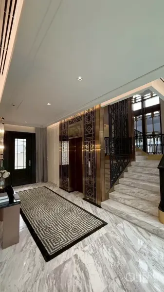 Detached House for sale in Saphan Sung, Bangkok - Grand foyer featuring a private elevator, marble staircase and decorative metal railings.