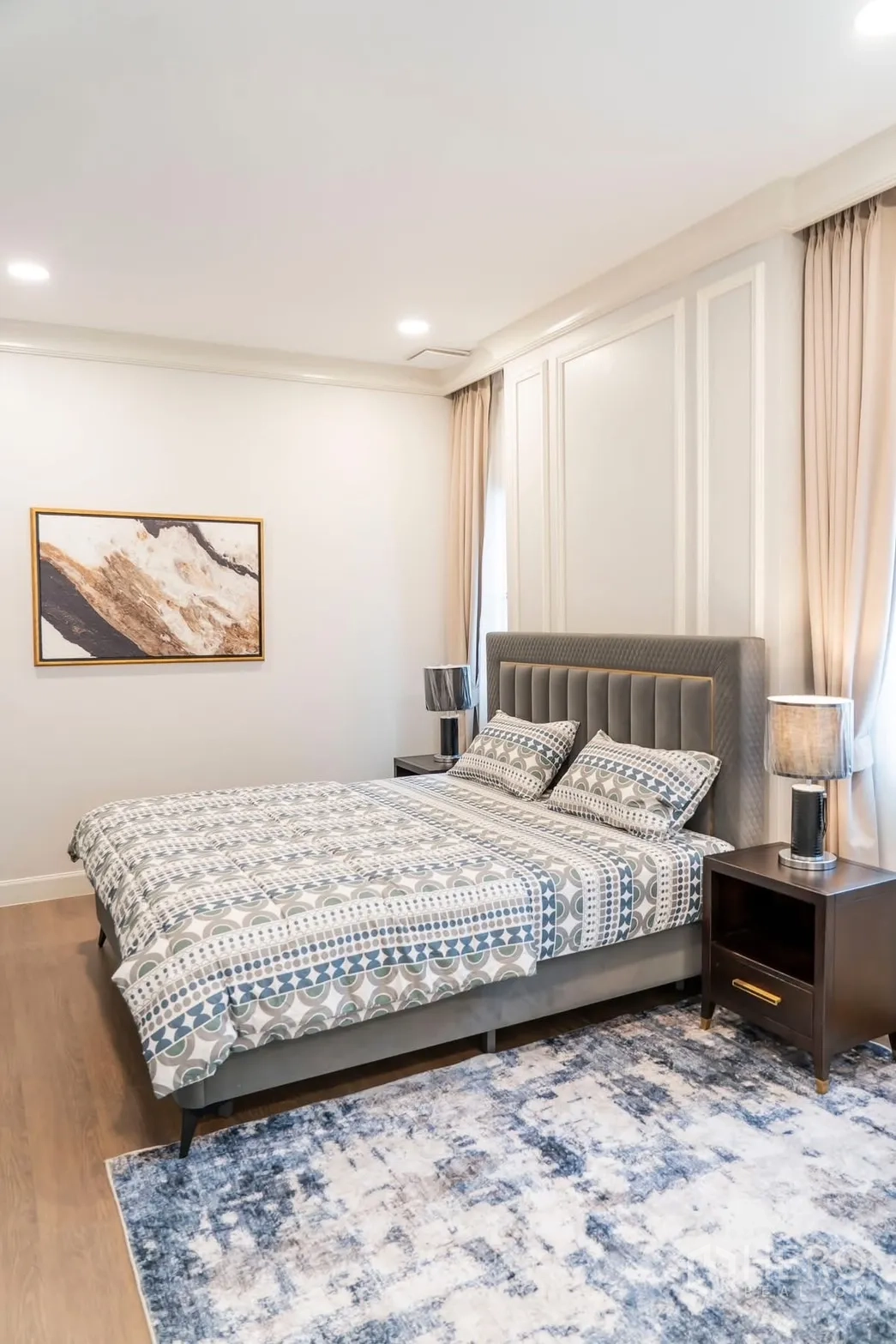 Detached House for rent in Saphan Sung, Bangkok - Large bedroom with grey upholstered bed and bedside tables.