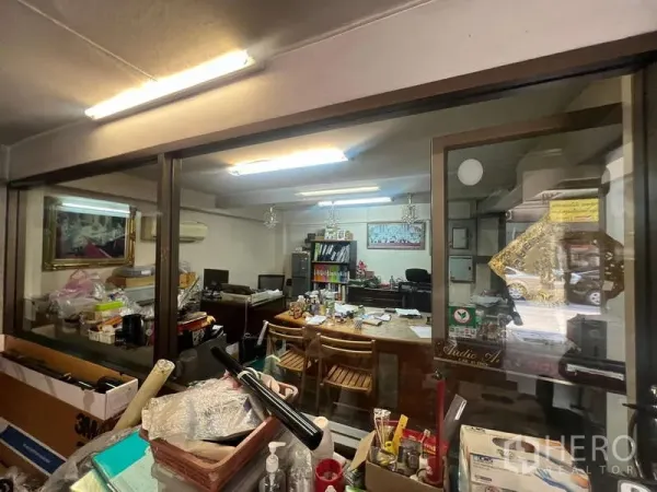 店屋 出租 - 玻璃隔断的办公室，荧光灯照明与办公桌。