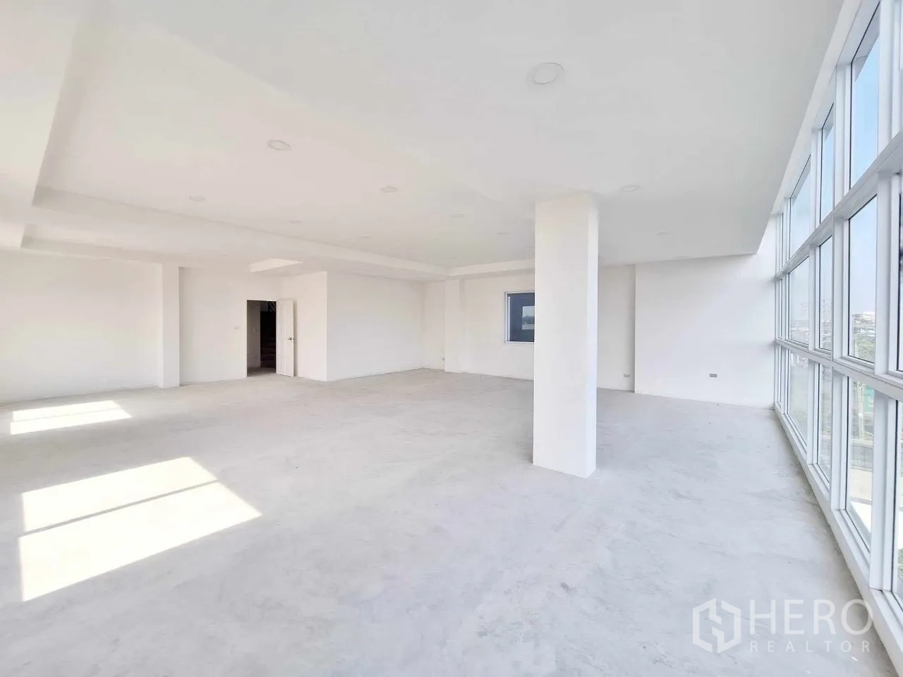 Office Space for sale in Bueng Kum, Bangkok - Large workspace with multiple windows providing city views.