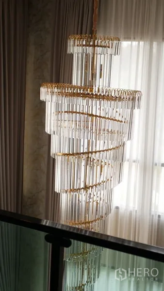 Detached House for rent or sale in Bang Bo, Samut Prakan - Statement spiral crystal chandelier by full-length curtains on the landing.