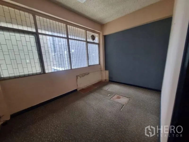 店屋 出租在Watthana, Bangkok - 小型办公间，格栅式窗户与深色强调墙。