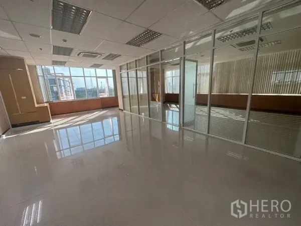 Office Space for rent in Suan Luang, Bangkok - Bright workspace with glass-partitioned rooms and large windows with city views.