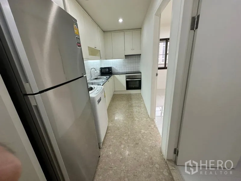 คอนโด ให้เช่าในWatthana, Bangkok - ครัวแบบแกลเล่ย์ตู้สีขาว ตู้เย็นสแตนเลส เครื่องซักผ้า และเตาอบบิลท์อิน
