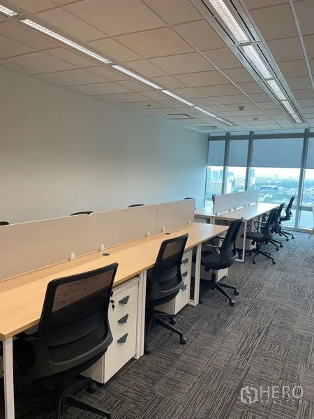 Office Space for rent in Dusit, Bangkok - Open-plan office with long workstations, ergonomic chairs and floor-to-ceiling windows overlooking Bangkok.